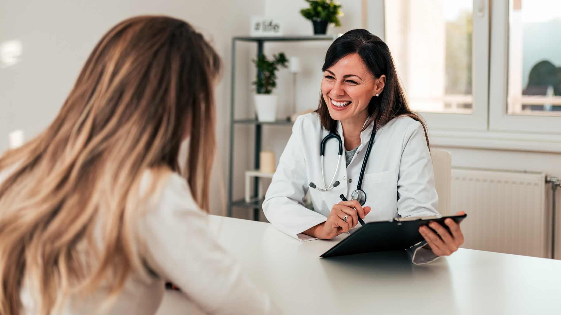 An image of two happy persons discussing a health coaching program